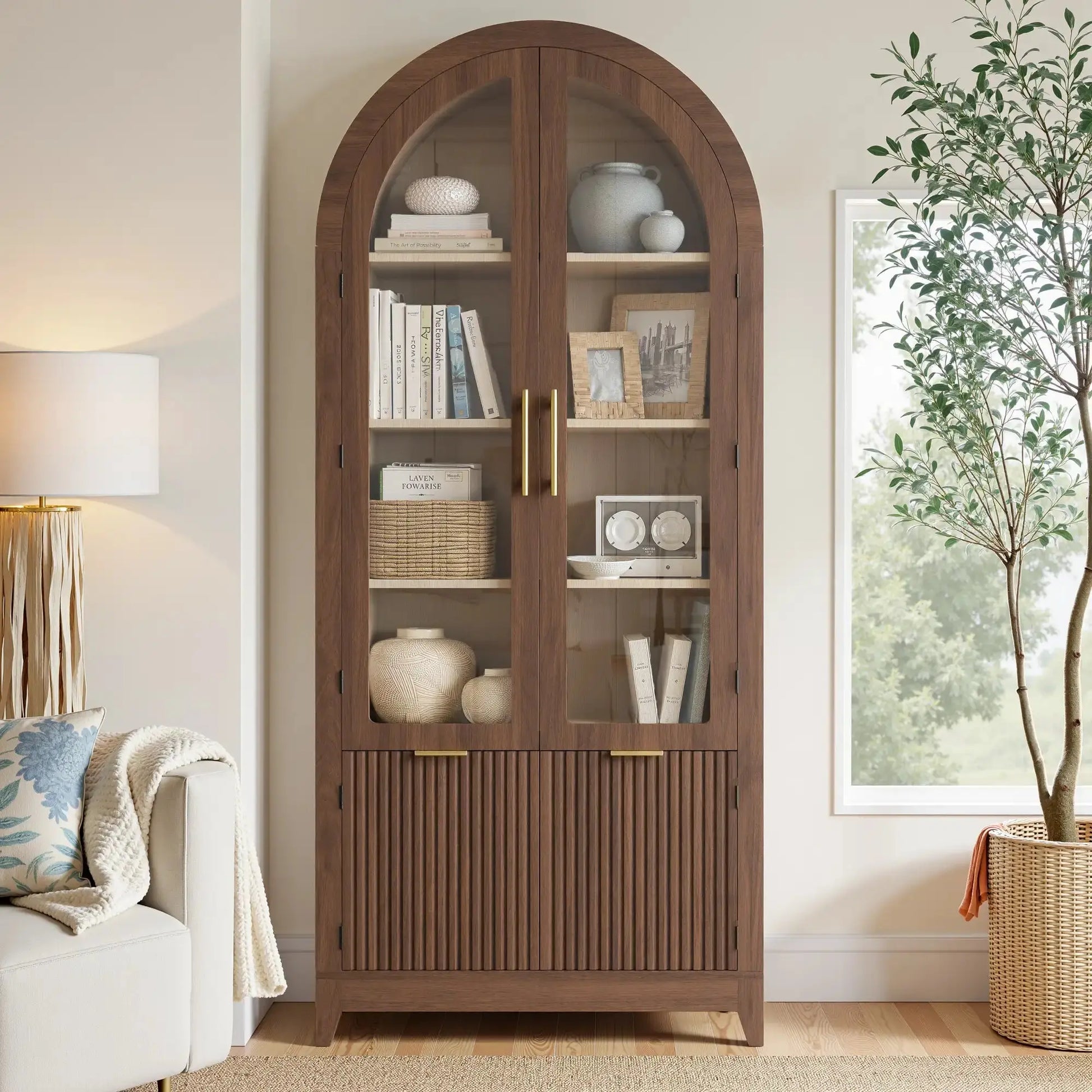 Win2Win Tall Arched Cabinet with Glass Doors, Walnut Storage Cabinet with Fluted Doors in a living room setting with a sofa, floor lamp, and large plant